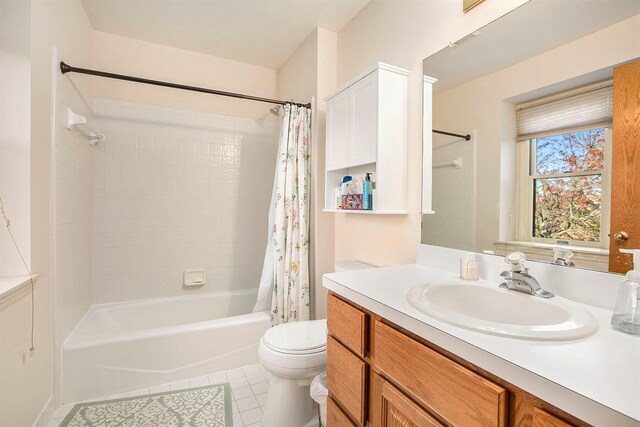 full bathroom featuring toilet, vanity, tile patterned floors, and shower / tub combo