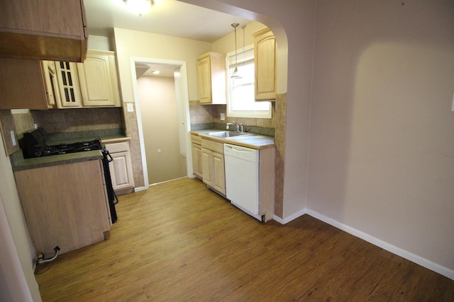 kitchen with light wood-type flooring, backsplash, white dishwasher, hanging light fixtures, and sink