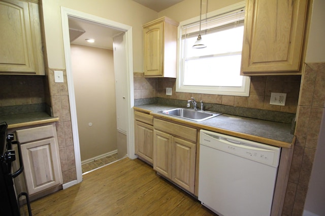 kitchen with white dishwasher, hardwood / wood-style floors, sink, light brown cabinetry, and decorative light fixtures