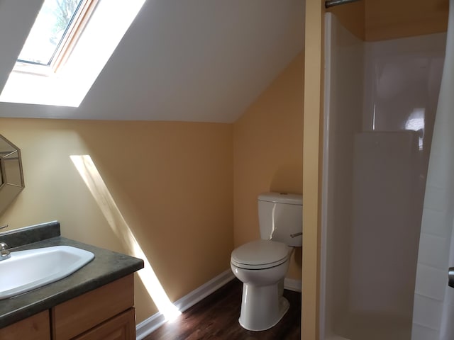 bathroom featuring hardwood / wood-style floors, vanity, lofted ceiling, a shower, and toilet