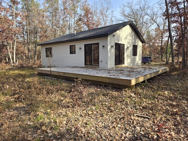 rear view of property featuring a wooden deck