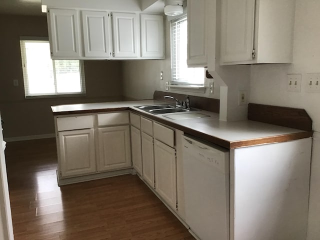 kitchen with white cabinets, dark hardwood / wood-style flooring, sink, and white dishwasher