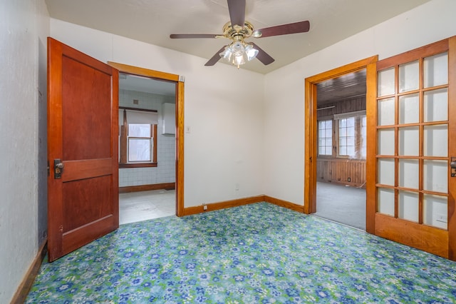 spare room with ceiling fan, a healthy amount of sunlight, and carpet