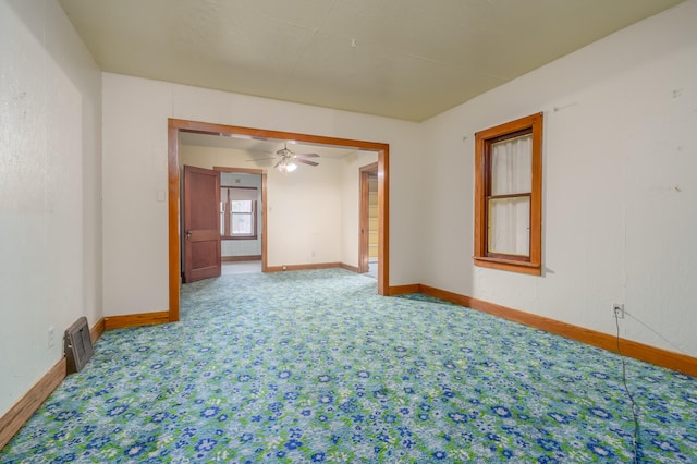 unfurnished room with ceiling fan