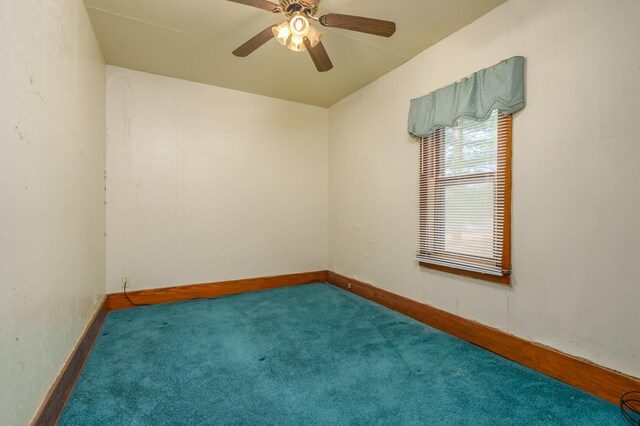 unfurnished room with ceiling fan and carpet flooring