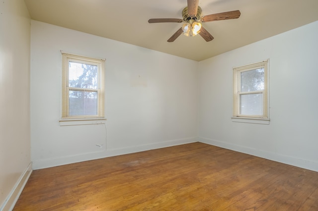 spare room with hardwood / wood-style floors and ceiling fan