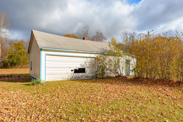 garage featuring a lawn