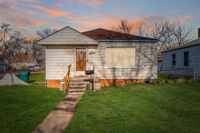 bungalow-style home featuring a lawn