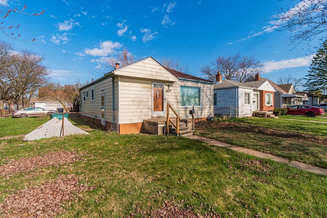 back of property featuring a lawn