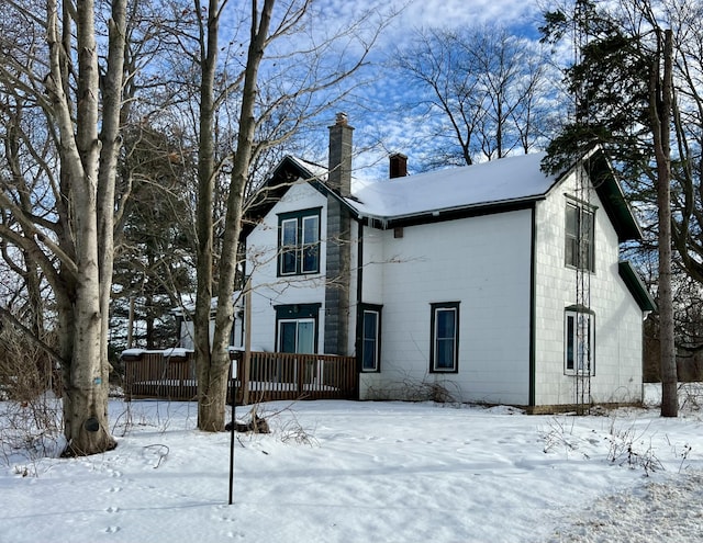 view of snow covered rear of property