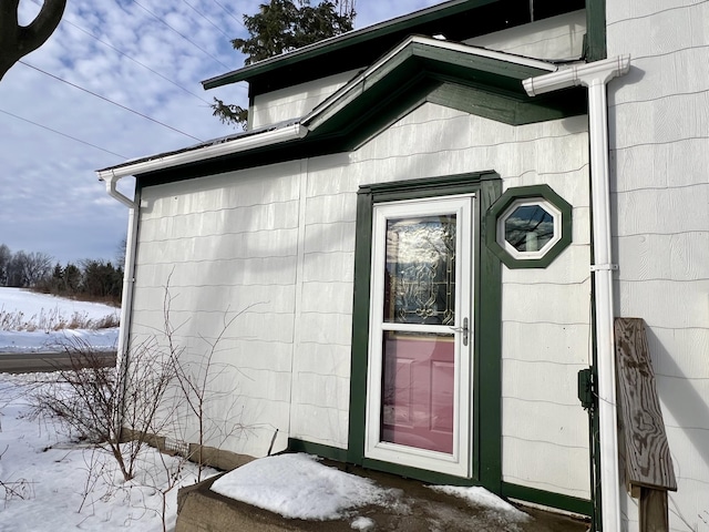 view of snow covered property entrance