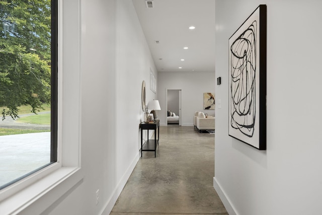 hallway with concrete flooring