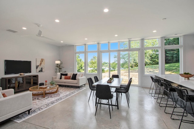 dining space with ceiling fan and floor to ceiling windows