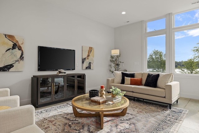 living room featuring a wealth of natural light and light tile patterned flooring