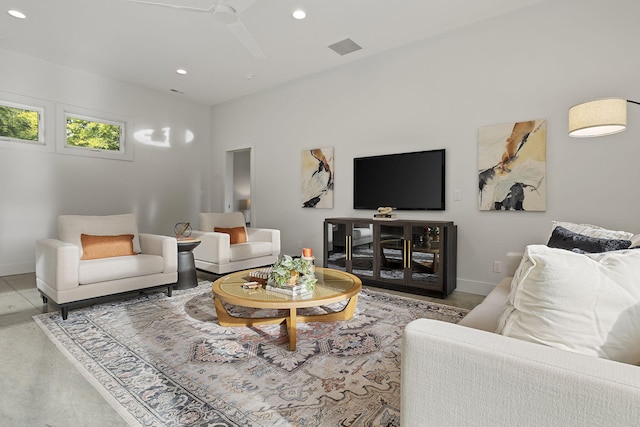 living room featuring concrete flooring and ceiling fan