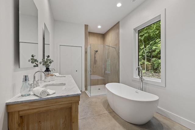 bathroom with vanity and separate shower and tub