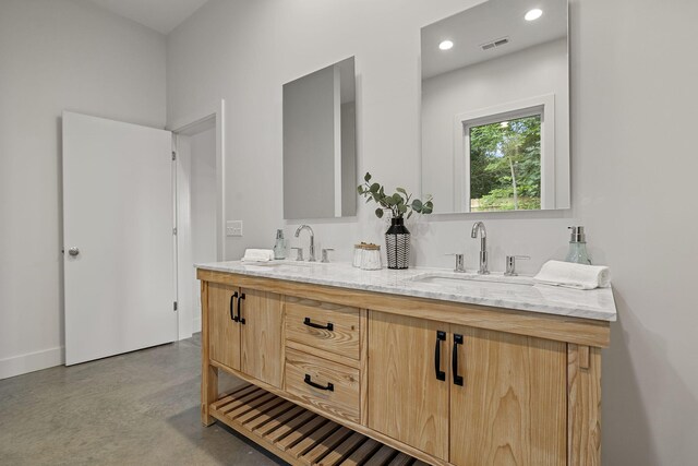 bathroom with vanity and concrete floors