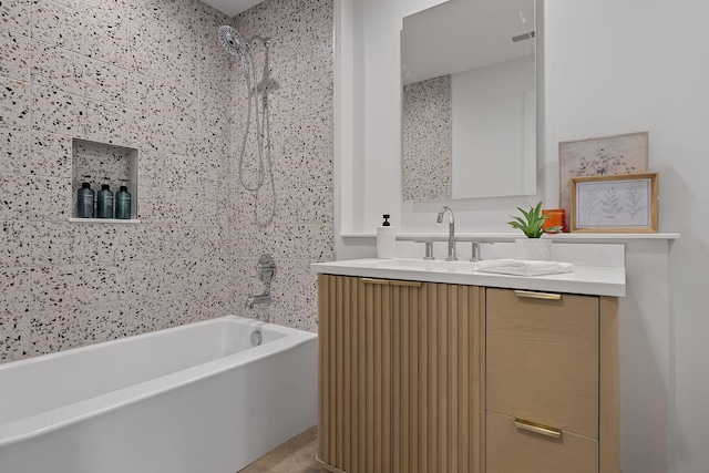 bathroom with vanity and tiled shower / bath combo