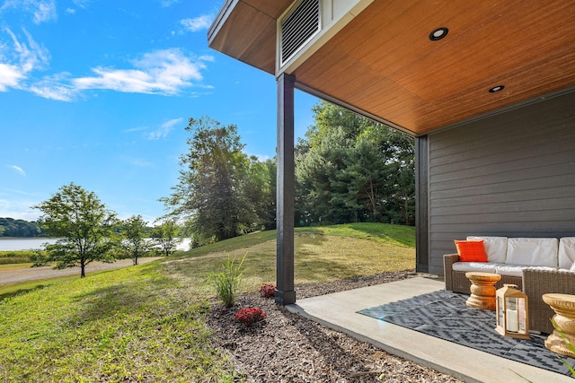 view of yard featuring a patio, a water view, and an outdoor hangout area