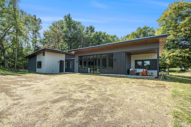 rear view of property featuring a yard