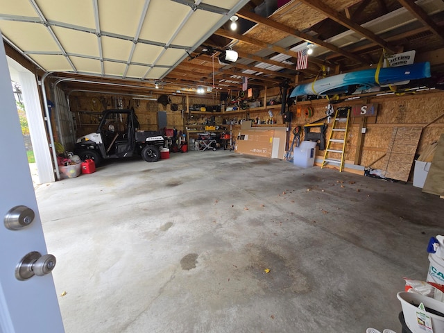 garage with a workshop area and a garage door opener