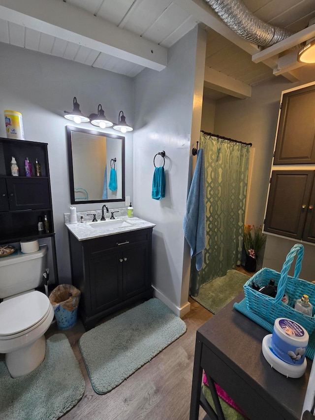 bathroom with wood-type flooring, toilet, wooden ceiling, vanity, and beamed ceiling