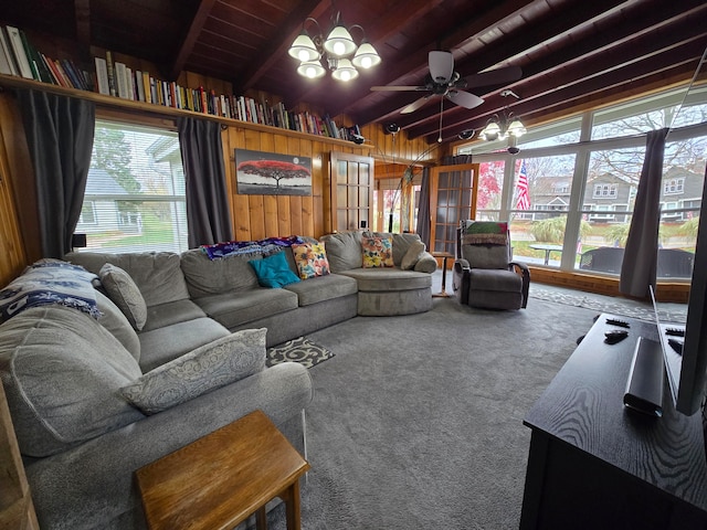 living room featuring a wealth of natural light, vaulted ceiling with beams, and carpet floors