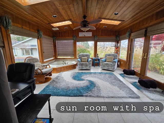 sunroom with vaulted ceiling with skylight, ceiling fan, wood ceiling, and a wealth of natural light