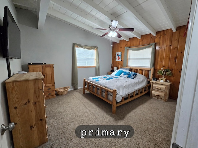 bedroom with carpet floors, wood walls, multiple windows, and ceiling fan