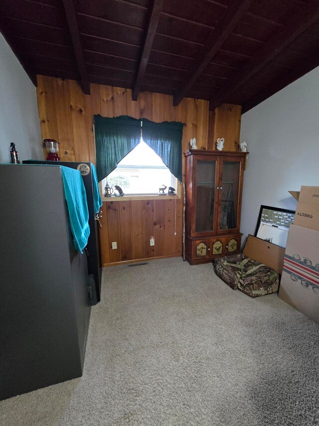 miscellaneous room featuring beamed ceiling, wooden ceiling, and carpet floors