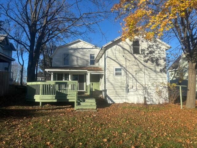 rear view of house featuring a porch