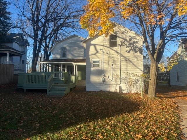 rear view of house featuring a deck