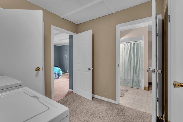 washroom featuring separate washer and dryer and light carpet