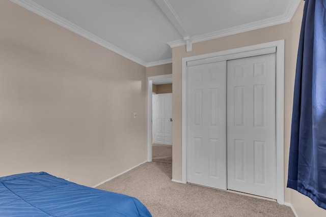 bedroom featuring ornamental molding, light carpet, and a closet