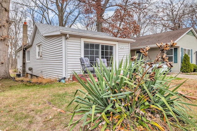 view of side of property with a yard