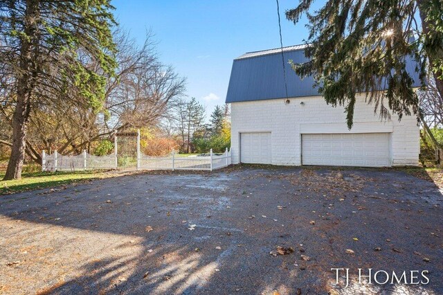 view of home's exterior featuring a garage and an outdoor structure