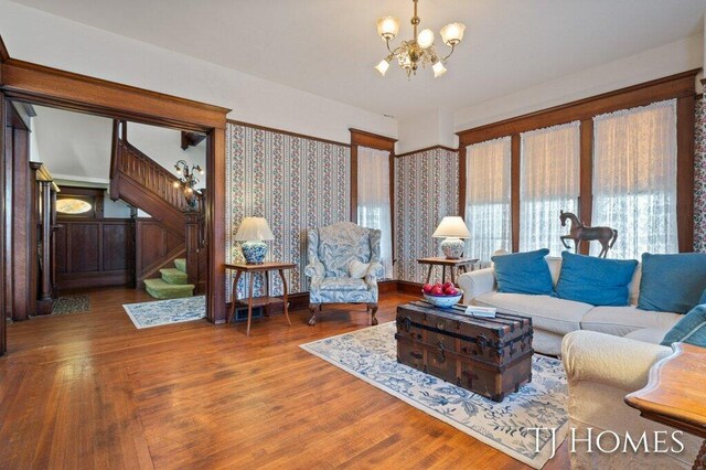 living room with an inviting chandelier and hardwood / wood-style floors