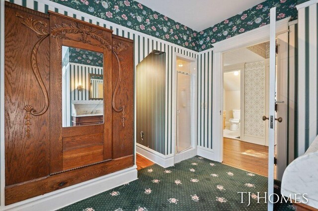 interior space featuring toilet and hardwood / wood-style floors