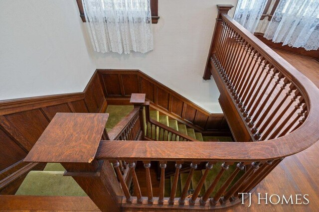 stairs with wooden walls and wood-type flooring