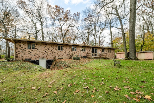 back of property with a lawn and a shed