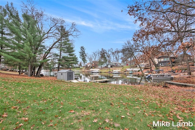 view of yard featuring a water view and a boat dock