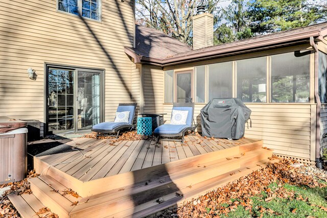 deck with grilling area and a sunroom