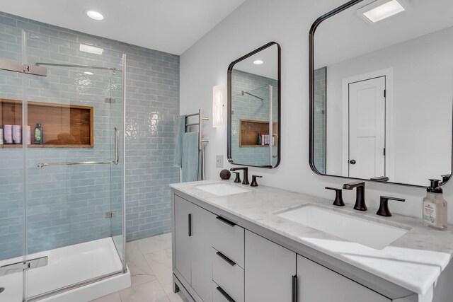 bathroom with an enclosed shower and vanity