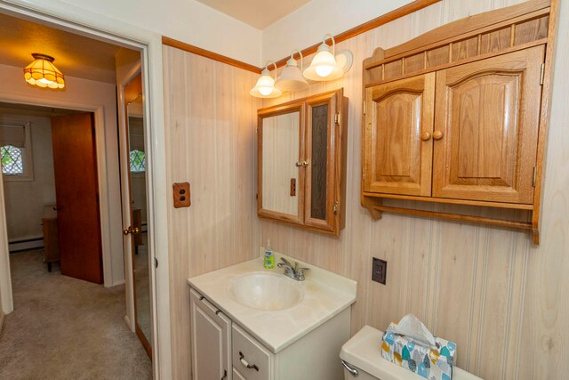 bathroom with vanity, toilet, and a baseboard heating unit