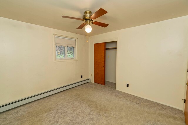 unfurnished bedroom featuring light carpet, a closet, a baseboard radiator, and ceiling fan