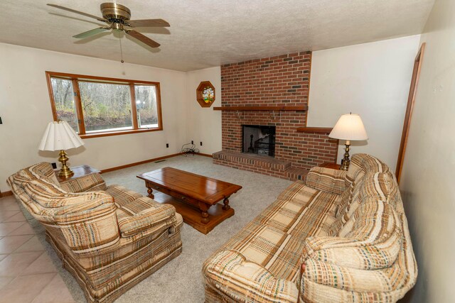 carpeted living room with a textured ceiling, a brick fireplace, and ceiling fan