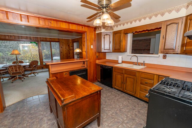 kitchen with dark carpet, ceiling fan, wooden walls, sink, and black appliances