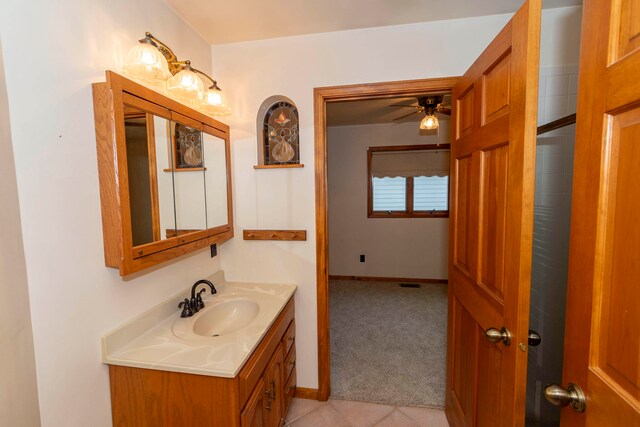 bathroom featuring tile patterned flooring, vanity, and ceiling fan