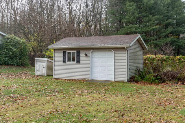 garage featuring a lawn