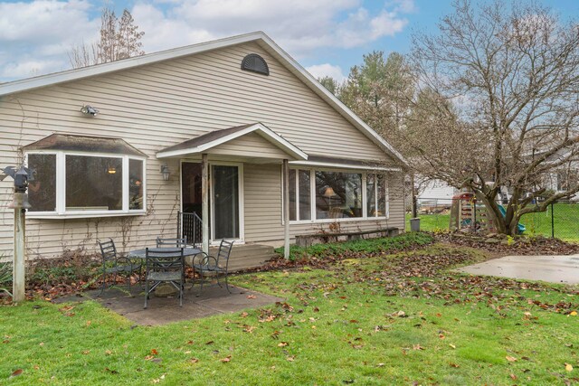 back of house featuring a patio and a lawn